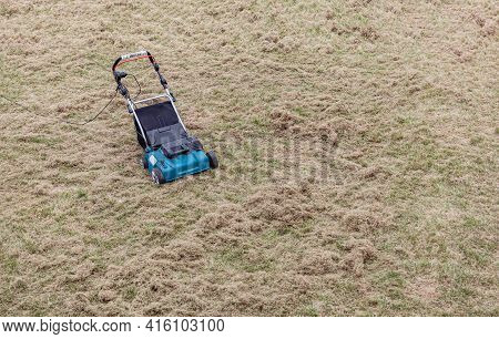 Scarifying Lawn With A Scarifier, Scarifies The Lawn And Removal Of Old Grass
