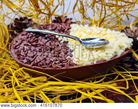 Brazilian easter egg stuffed with granulated chocolate and cream, tasted with a spoon. Easter tradition in Brazil