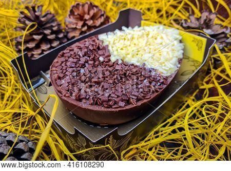Brazilian easter egg stuffed with granulated chocolate and cream, tasted with a spoon. Easter tradition in Brazil