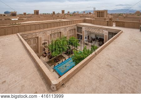 Yazd, Iran - 14.04.2019: Rooftops Of Historical Ciry Of Yazd, Iran. Small Patio Garden In The Front.