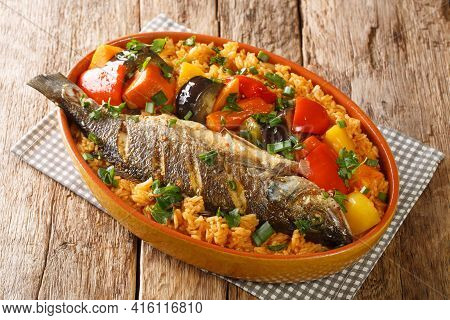 Senegalese Food Thieboudienne Cooked Rice And Fish With Vegetables Close-up In A Dish On The Table. 