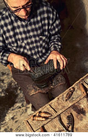 cobbler at work with old tools