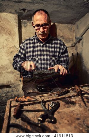 cobbler at work with old tools