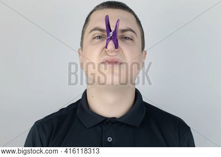 A Man With Bad Breath Looks At The Camera. Fetid Odor Concept. Close-up Of A Person Who Hears A Sten