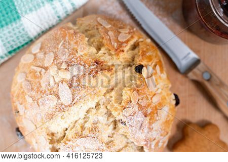 Freshly Baked, Homemade Sweet Cake With Almonds And Raisins On Wooden Board. Easter Loaf. Knife With