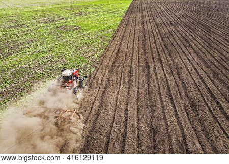 A Large Agricultural Machine Cultivates The Land. The View From The Top. Plowing Land For Planting C