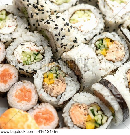 Sushi Tuna Rolls Decorated With Sesame Seeds And Masago Or Tobiko Caviar. Inside-out Sushi Set. Diff