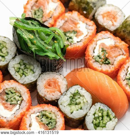 Sushi And Sushimi Set. Different Types Of Sushi Rolls And Sushimi With Salmon And Seaweed. Asian Or 