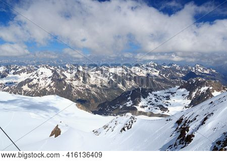 Mountain Snow Panorama On Main Chain Of The Alps Seen From Summit Wildspitze And Blue Sky In Tyrol A