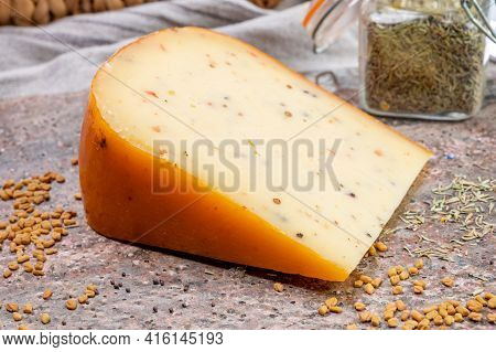 Cheese Collection, Piece Of Hard Yellow Dutch Gouda Cheese With Dried Caraway, Mustard, Cumin, Peppe