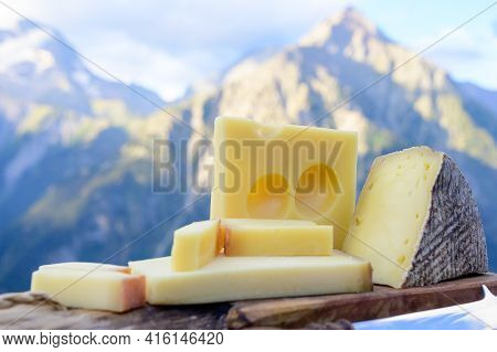 Cheese Collection, French Beaufort, Abondance, Emmental, Tomme De Savoie Cheeses Served Outdoor In S
