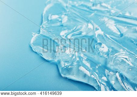 Gel With Hyaluronic Acid In The Form Of A Smear Of Glossy Texture On A Blue Background.