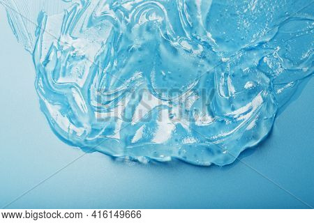 Gel With Hyaluronic Acid In The Form Of A Smear Of Glossy Texture On A Blue Background.