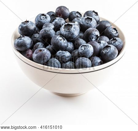 Fresh And Raw Blueberries With Drops Of Water. In White Bowl And Ready To Eat. Isolated With Copy Sp