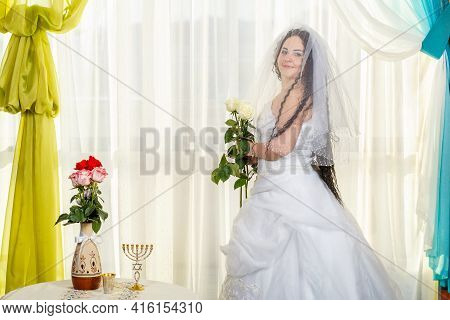 A Jewish Bride In A Synagogue With A Veil Covered Before A Chuppa Ceremony During A Pandemic, Wearin