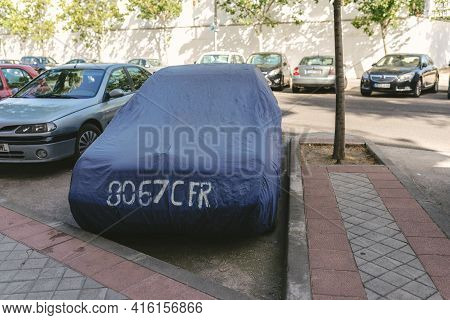 Madrid, Spain - August 6, 2018 - Covered By A Car With A Tarpaulin In The Herrera Oria District Of M