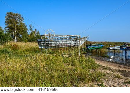 Beautiful Landscape With Boats Hanging Over The Water And A Grassy Beach. Leningrad Region. Russia. 