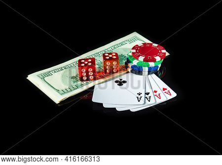 Four Of A Kind Or Quads Cards And Dollars With Chips And Dice In The Background. Winning Combination