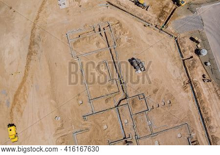 Aerial View Construction Work In The Laying Pipes In The Foundation For New Residential Complex Buil
