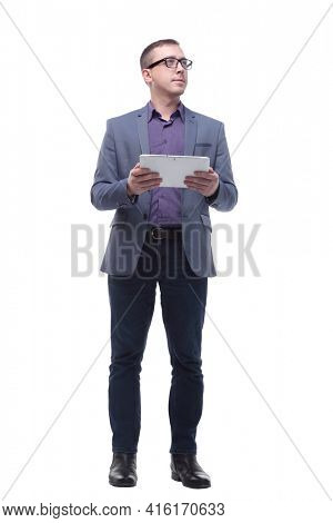 Full lenth portrait of cool businessman using electronic tablet