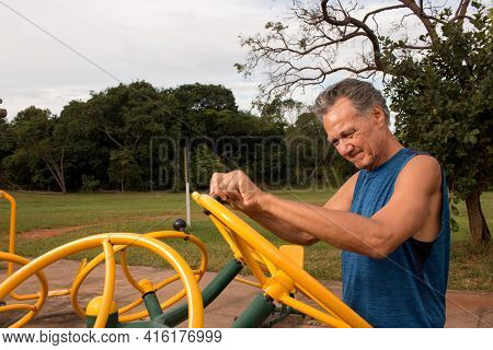 Senior Man Working Out At An Outdoor Fitness Park In Parque Das Garças, Brasilia