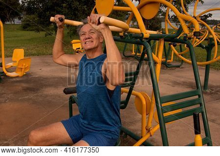 Senior Man Working Out At An Outdoor Fitness Park