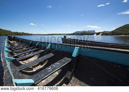 Blue Wooden Boats In Front Of Hacha Falls In The Lagoon Of Canaima National Park Venezuela 2015.