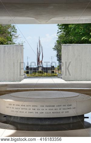 CORREGIDOR, PHILIPPINES - APRIL 3, 2016: Flame of Freedom. The flame is seen from the Pacific War Memorial with inscription in the foreground.