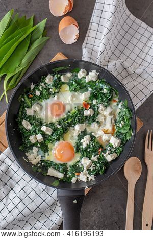 Green Shakshuka. Fried Eggs With Wild Garlic And Feta Cheese