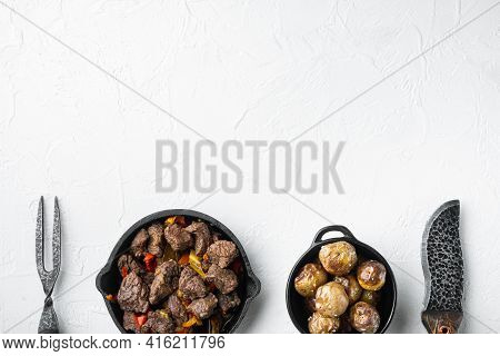 Mongolian Beef, Pieces Of Beef Stewed In Soy Sauce Set, In Cast Iron Frying Pan, On White Stone  Sur