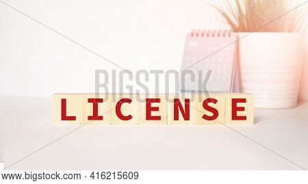 Lisence Is Written On Wooden Cubes On A White Background. The Concept Of Giving A Person The Right T