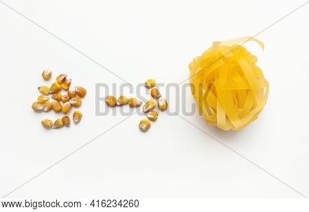 Tagliatelle Corn Paste. Gluten-free Corn Paste And Corn Grains On A White Background.