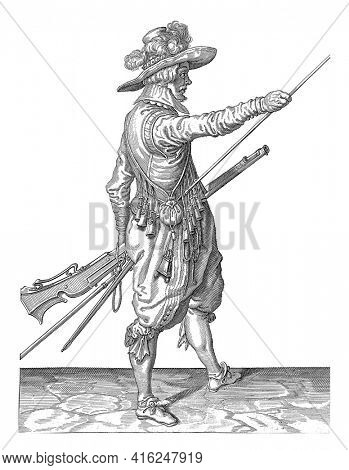 A Soldier, to the right, holding a musket with his left thigh and bringing his right hand to the end of his ramrod, which he leans against his right side, vintage engraving.