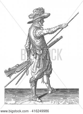 A Soldier, to the right, holding a musket with his left thigh and bringing his right hand to the end of his ramrod, which he leans against his right side, vintage engraving.