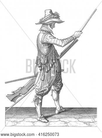 A soldier, full-length , to the right, who is holding a musket with his left thigh and with his right hand slides the ramrod into the holder under the barrel, vintage engraving.