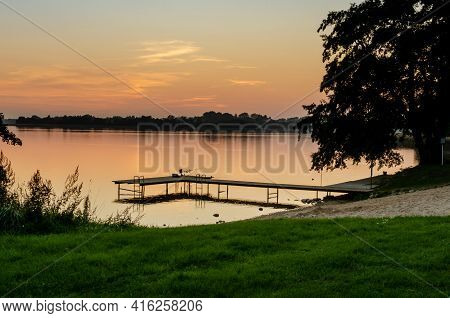 Fishing Equipment On The Pier At The Lake In Masuria. The Pier, The Quiet Święcajty Lake, Sunset