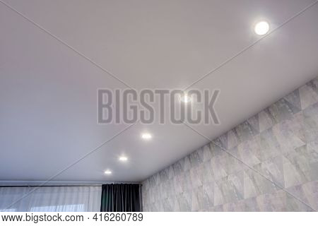 Suspended Ceiling With Halogen Spots Lamps And Drywall Construction In Empty Room In Apartment Or Ho