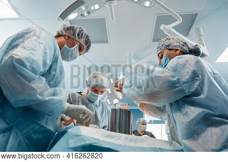 Cosmetic Liposuction Surgery In Actual Operating Room Setting Showing Surgeon Hands And Cannula
