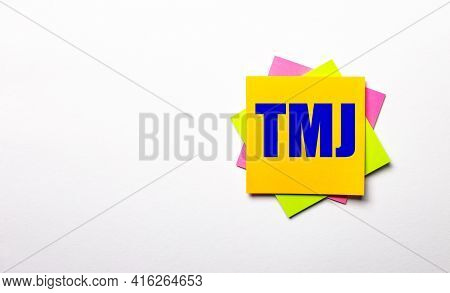 On A Light Background - Bright Multicolored Stickers With The Text Tmj. Copy Space