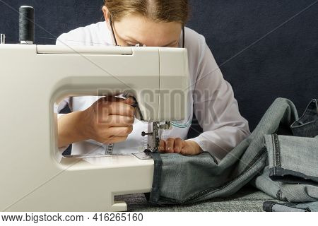 Process Of Shortening Jeans Pants On A Sewing Machine