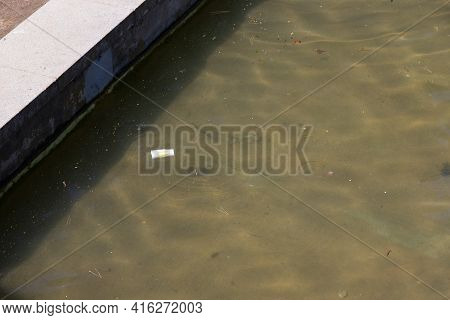 Sabadell, Spain - 21 March 2021 - Broken And Wet Paper Cup For Drinks From Mc Donalds Floating In A 