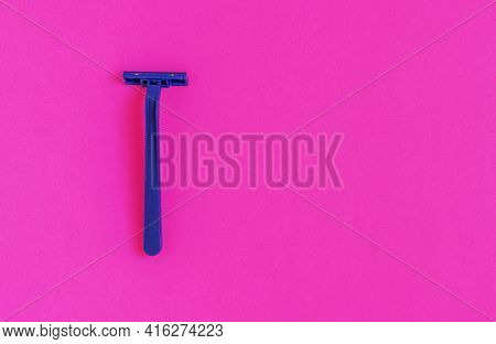 Non-permanent Blue Plastic Shaving Machine Isolated On Pink Background.
