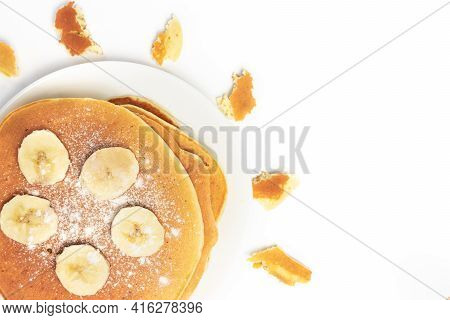 Pancakes With Banana And Powder On White Background In The Shape Of The Sun, Isolated Top View Close
