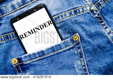 Reminder Text The Text Is Written On The Phone Screen That Lies On The Jeans. Word