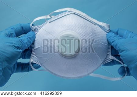 Ppe, Gloved Hands Holding A Mask With A Filter, White Filter Mask Ffp1