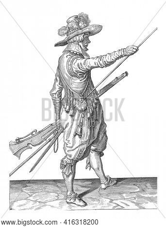 Soldier with a musket sliding his right hand to the end of his ramrod, vintage engraving.