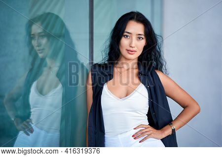 Fashion Close-up Portrait Of Young Woman Posing  Near To Showcase