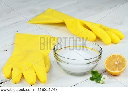 Crystalline Citric Acid And Lemon In A Bowl, Good For Cleaning. Rubber Gloves And Lemon Cut In Half 