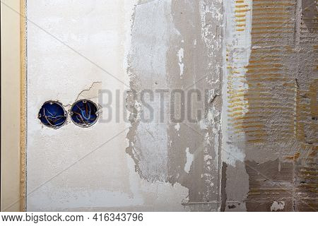 Electrical Wire And Opened Junction Box On Don\'t Plastered Wall. Home Renovation Concept