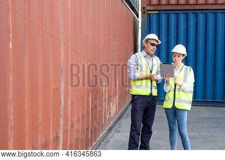 Caucasian Men And Women Freight  Supervisor Wearing Safety Vest And Hat While Inspect Condition Of A